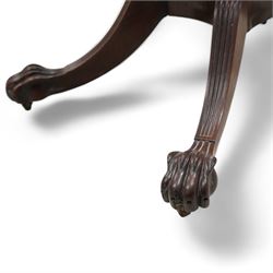 Regency mahogany card table, rectangular swivel and fold-over top with canted corners and reed-moulded edge, raised on a reeded pedestal with acanthus carved terminal and gardrooned collar, the concave rectangular base terminating to splayed supports with large paw feet on castors