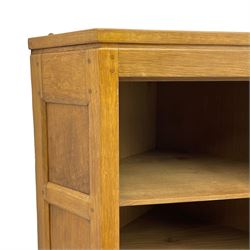 Rabbitman - oak corner cabinet, astragal glazed door enclosing three internal shelves, panelled upright corners, fitted with wrought metal hinges and latch, carved with rabbit signature, by Peter Heap, Wetwang 