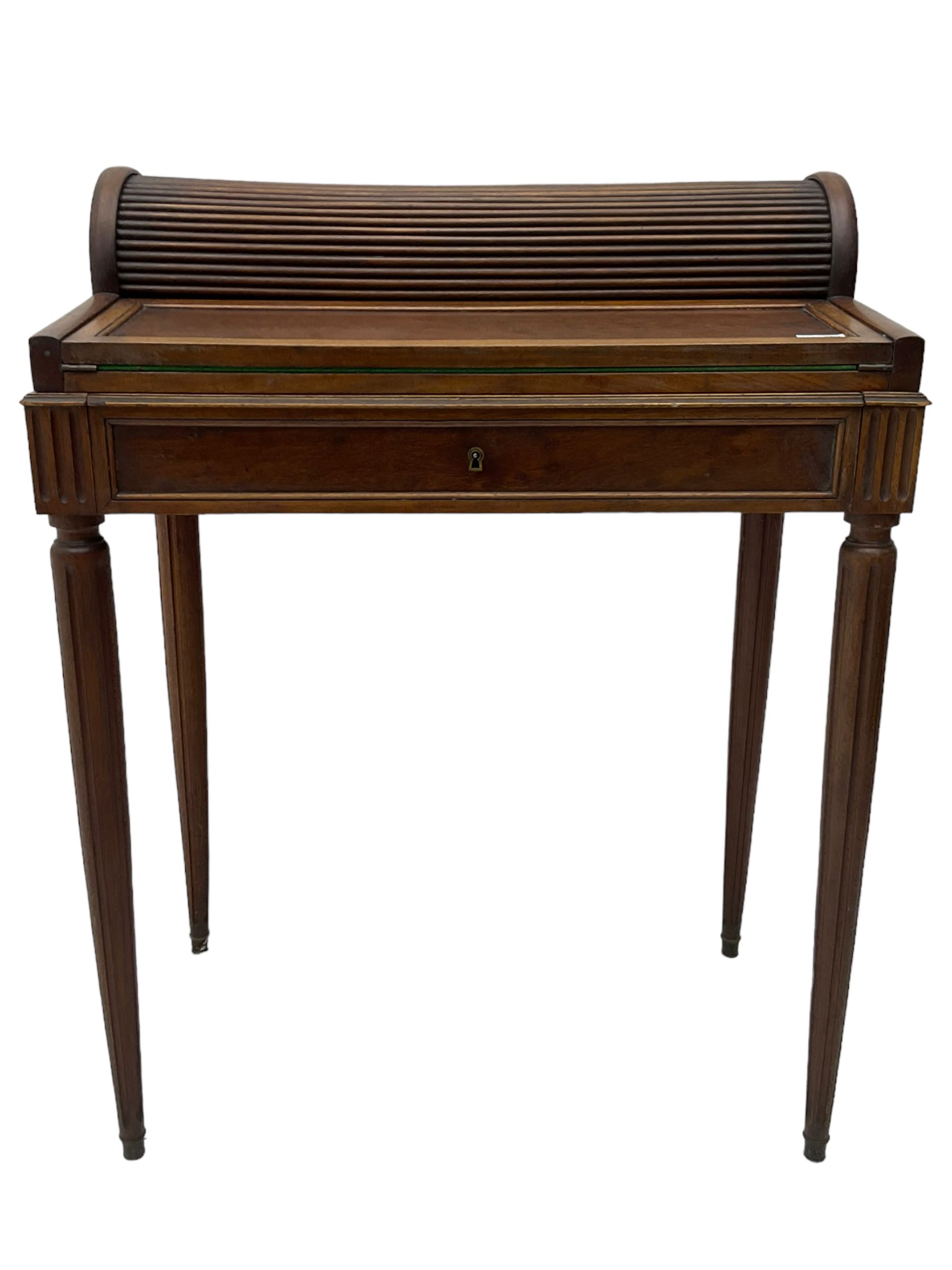 Early 20th century French plum pudding mahogany petite writing desk, barrel tambour roll top, fitted with a single cock-beaded drawer activating the tambour roll, the fold-over writing slope with inset writing surface supported by long drawer, fitted with three small drawers and pen rail, raised on fluted tapering supports