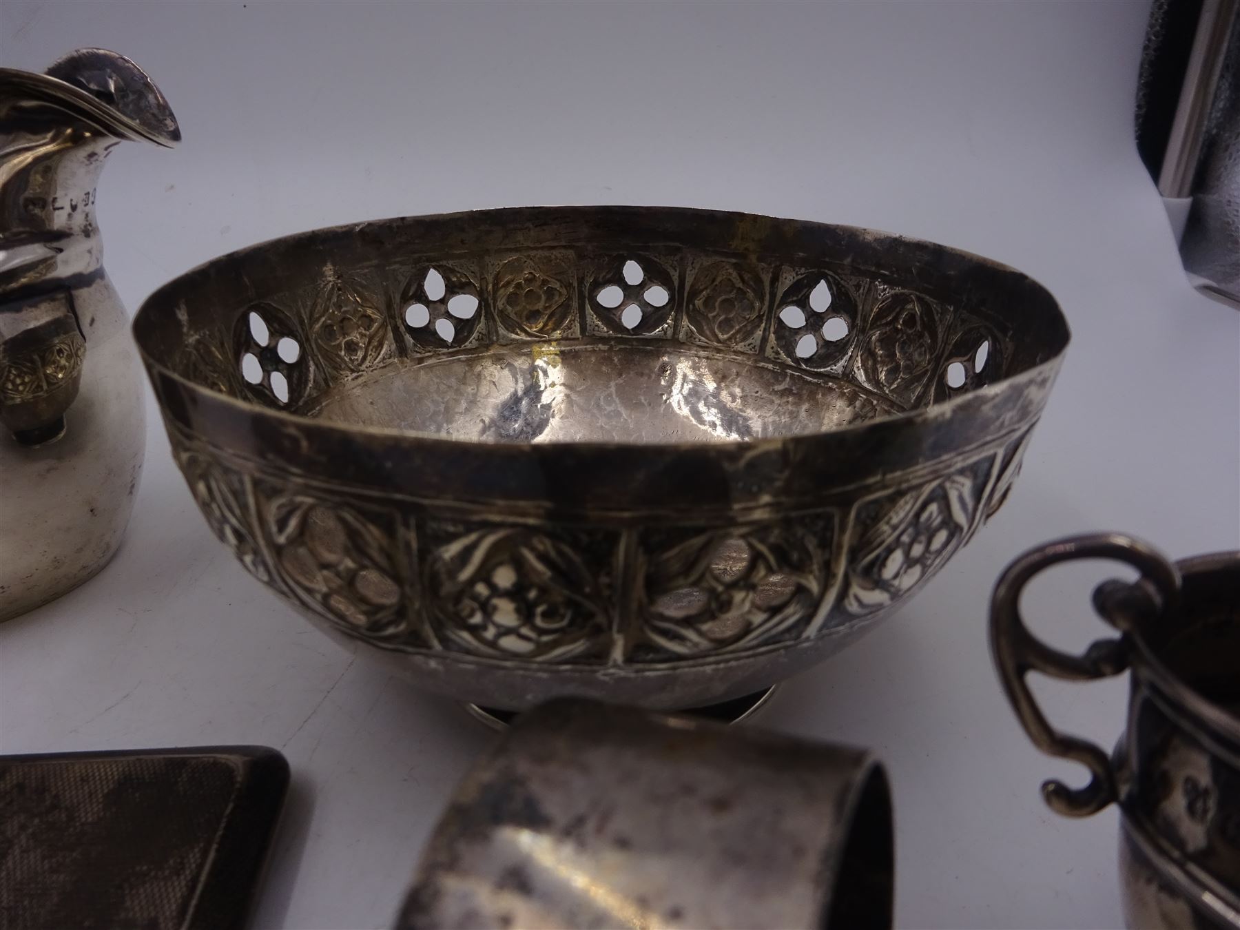 Group of silver, comprising milk jug, miniature trophy, napkin rings and cigarette cases, all hallmarked together with a continental silver bowl with pierced sides, jug H10cm