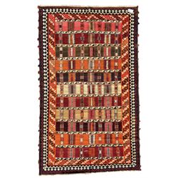 Southwest Persian Qashqai Kilim ground rug, featuring a series of horizontal striped panels each filled with intricate geometric designs, enclosed by a dark blue and ivory border with stylised star and zigzag motifs