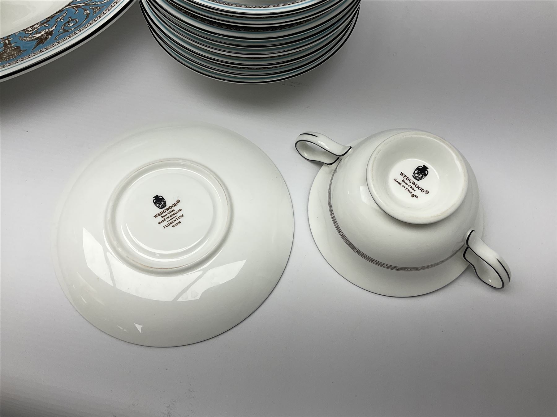 20th century Wedgwood dinner service for eight place settings, decorated in the Turquoise Florentine pattern, comprising dinner plates, salad plates, dessert plates, twin handled soup bowls and saucers, bowls, sauce boat and stand, teapot and two oval platters, with black printed marks beneath