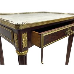 Late 19th century French figured plum pudding mahogany side table, canted rectangular white marble top with raised gilt metal gallery, fitted with a single frieze drawer, central extending floral cast ormolu escutcheon and applied moulded edging, on tapering turned and fluted supports with brass cups and castors, decorated with cast foliate mounts and foliate cast collars 