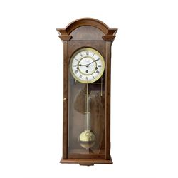 Comitti,  London - 20th century 8-day chiming wall clock in a walnut case, with a moulded break-arch top and full length glazed door and side panels, two part enamel dial with spade hands and visible gridiron pendulum, three train spring driven movement chiming the quarters on 5 gong rods.