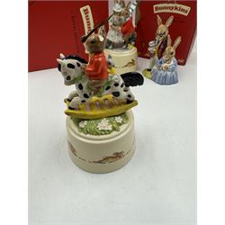 Two Royal Doulton Bunnykins music boxes, comprising Rocking Horse and Winter Waltz together with two Royal Doulton Bunnykins figures Once Upon a Time and Father, Mother & Victoria, all with original boxes  