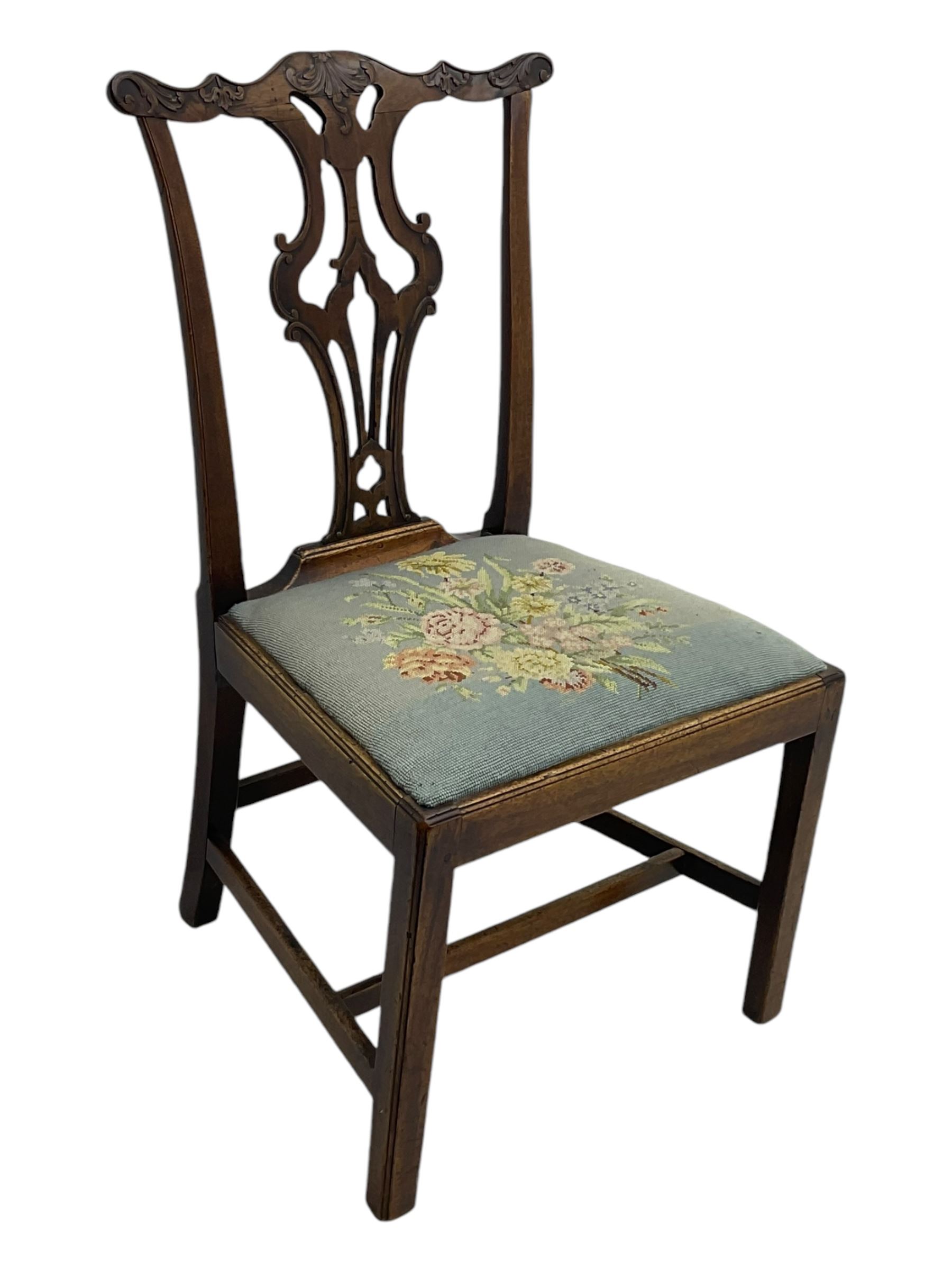 George III Chippendale design dining chair, shaped cresting rail carved with foliate scrolls over pierced and carved splat, floral needle-work upholstered drop-in seat, on square moulded supports united by H-stretchers 