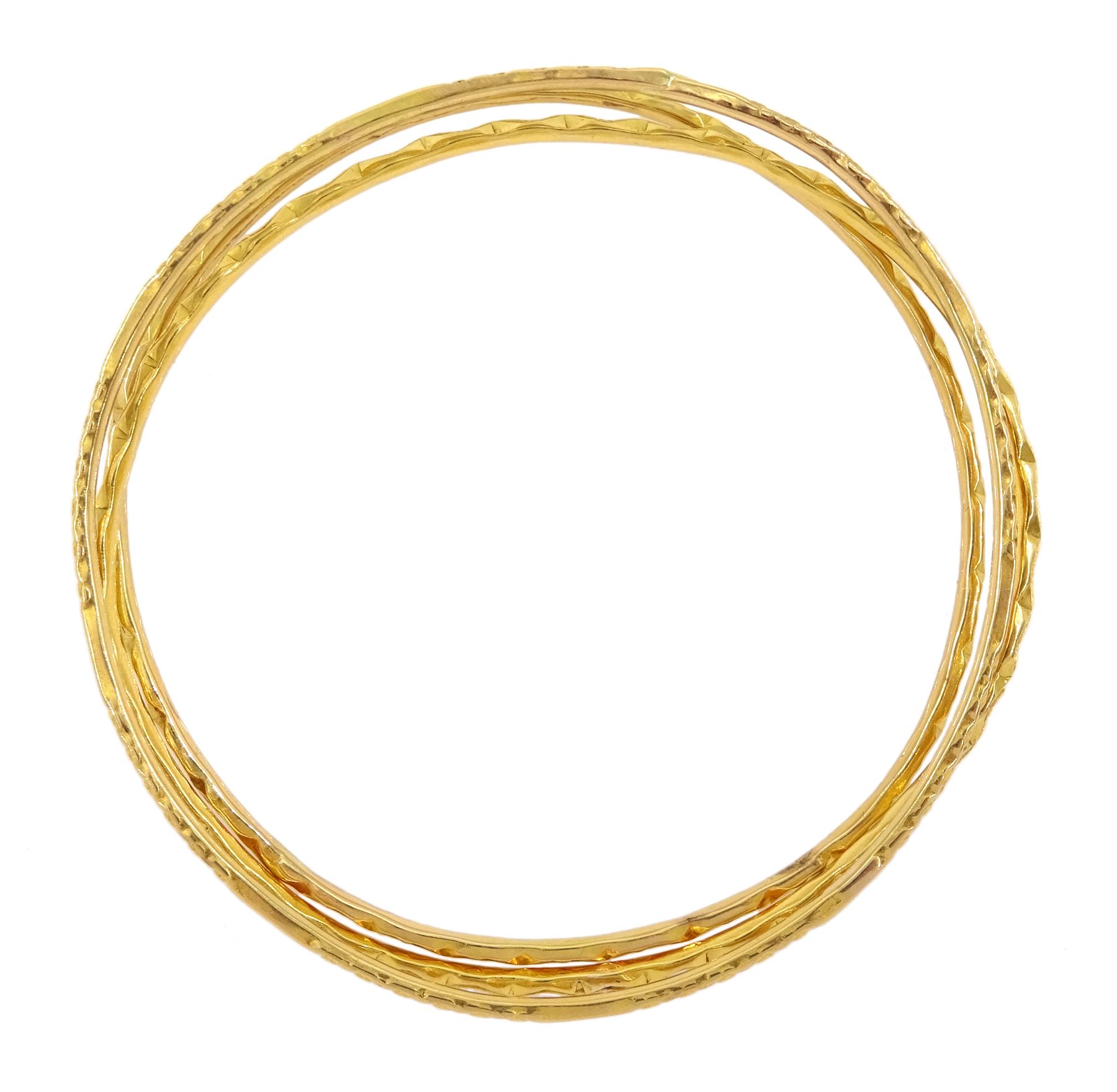 Three Middle Eastern 20ct and 21ct gold bangles