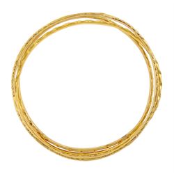 Three Middle Eastern 20ct and 21ct gold bangles