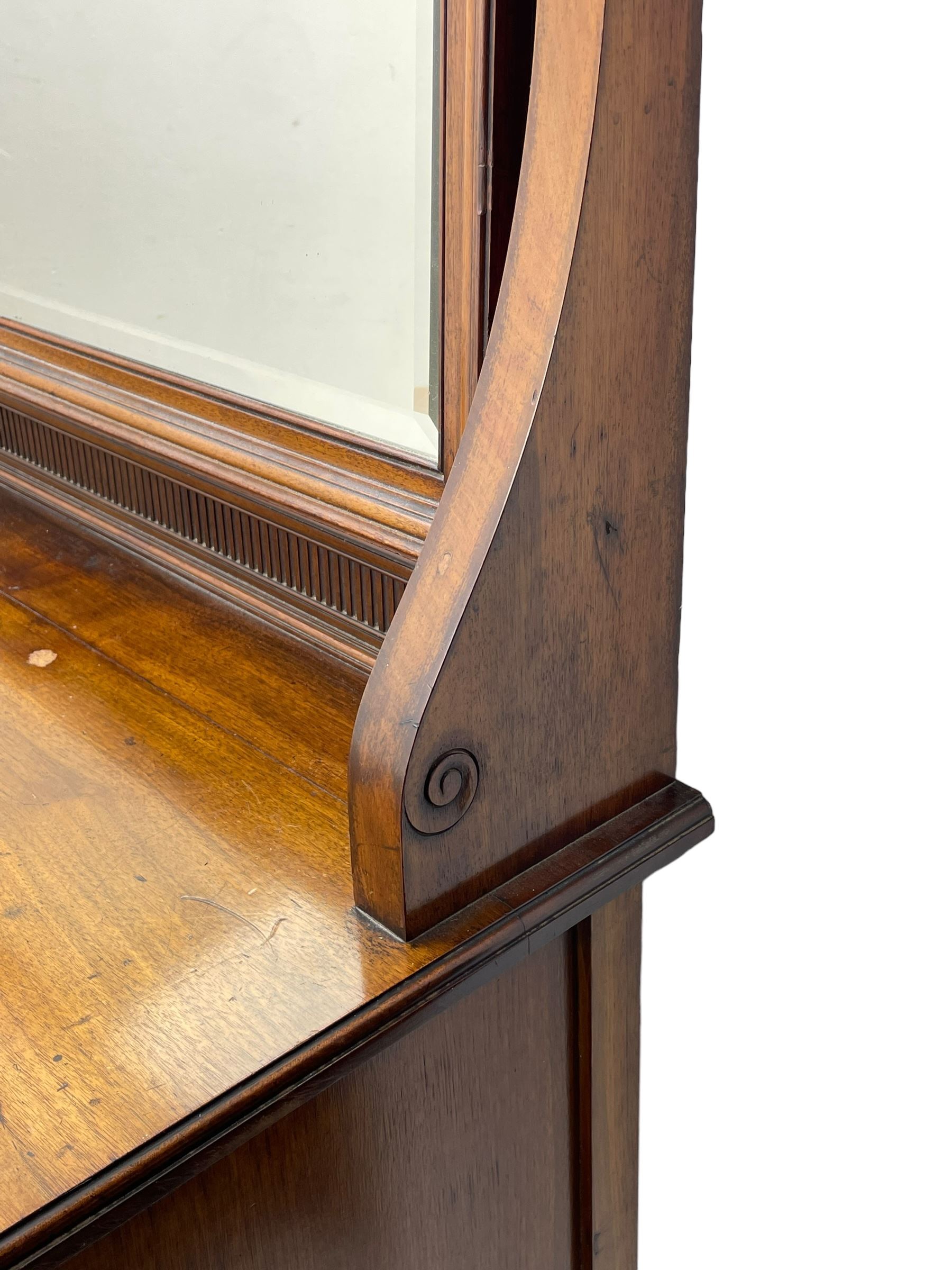 Late 19th century walnut dressing table, wide rectangular bevelled swing mirror in moulded frame, shaped horns carved with scrolls, moulded rectangular top over seven drawers, on square tapering supports with spade feet 