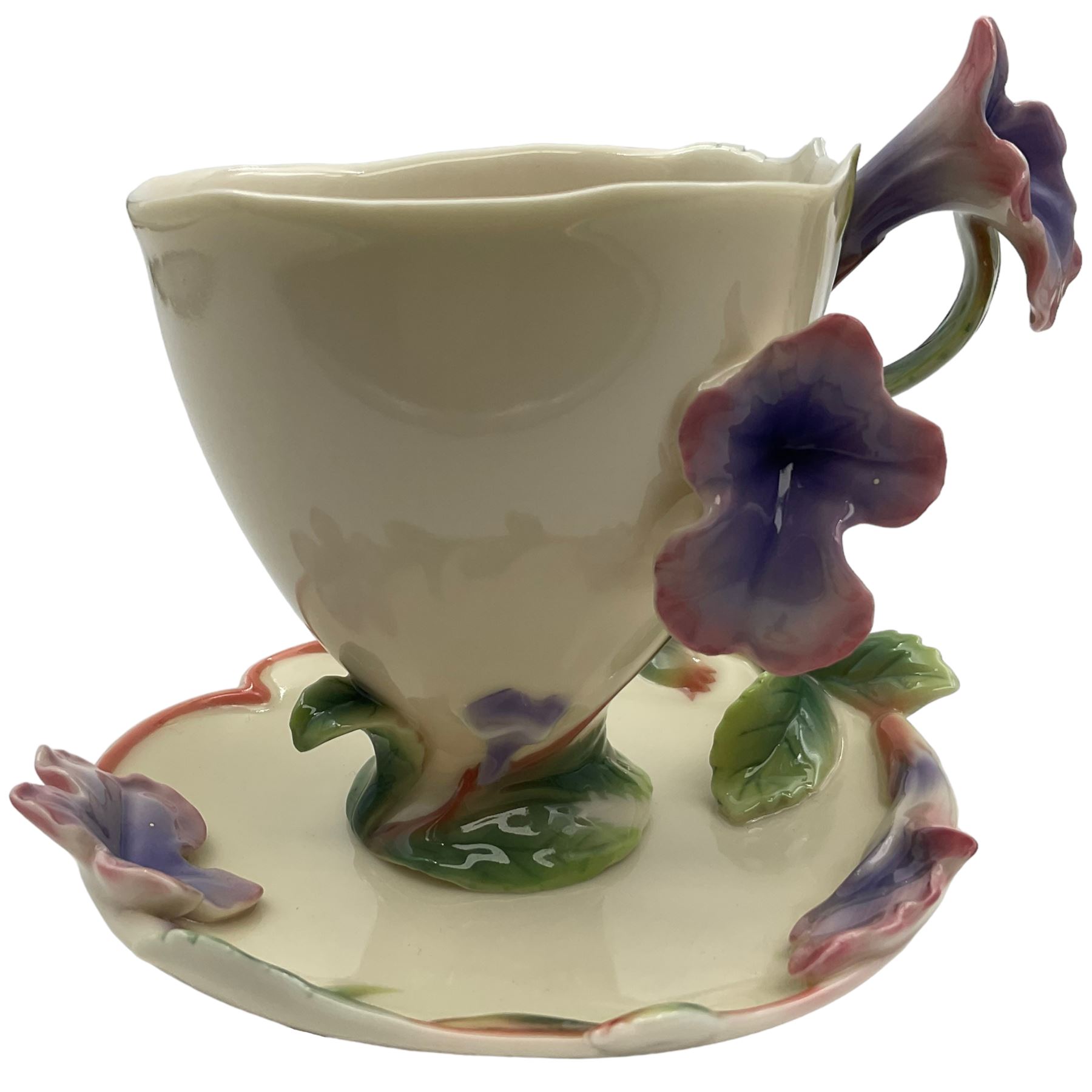 Two Franz teacups and saucers, decorated with flowers, one with matching teaspoon