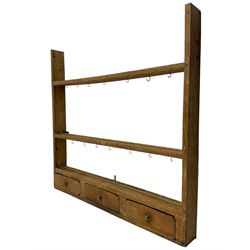 19th century pine plate rack, three tiers over three drawers with brass handles 