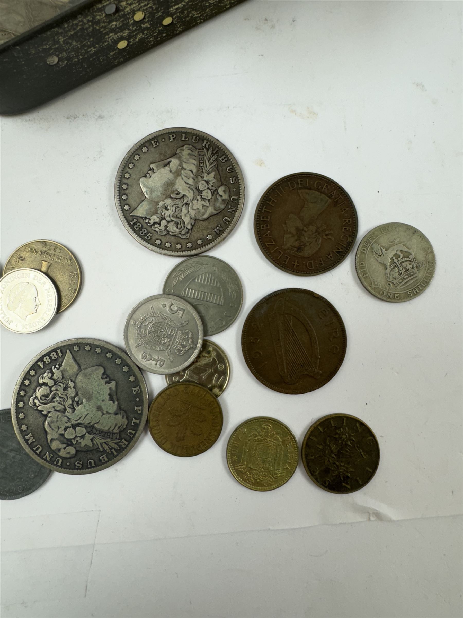 Various coins and banknotes including two Morgan dollars, in a vintage tin