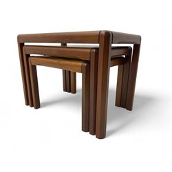 Mid-20th century nest of three teak tables, rectangular tops with inset glass, raised on c...