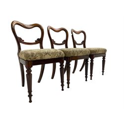Set of six Victorian rosewood shaped balloon back dining chairs, C-scrolled middle rail carved with foliage, upholstered drop-on seats, on turned front supports