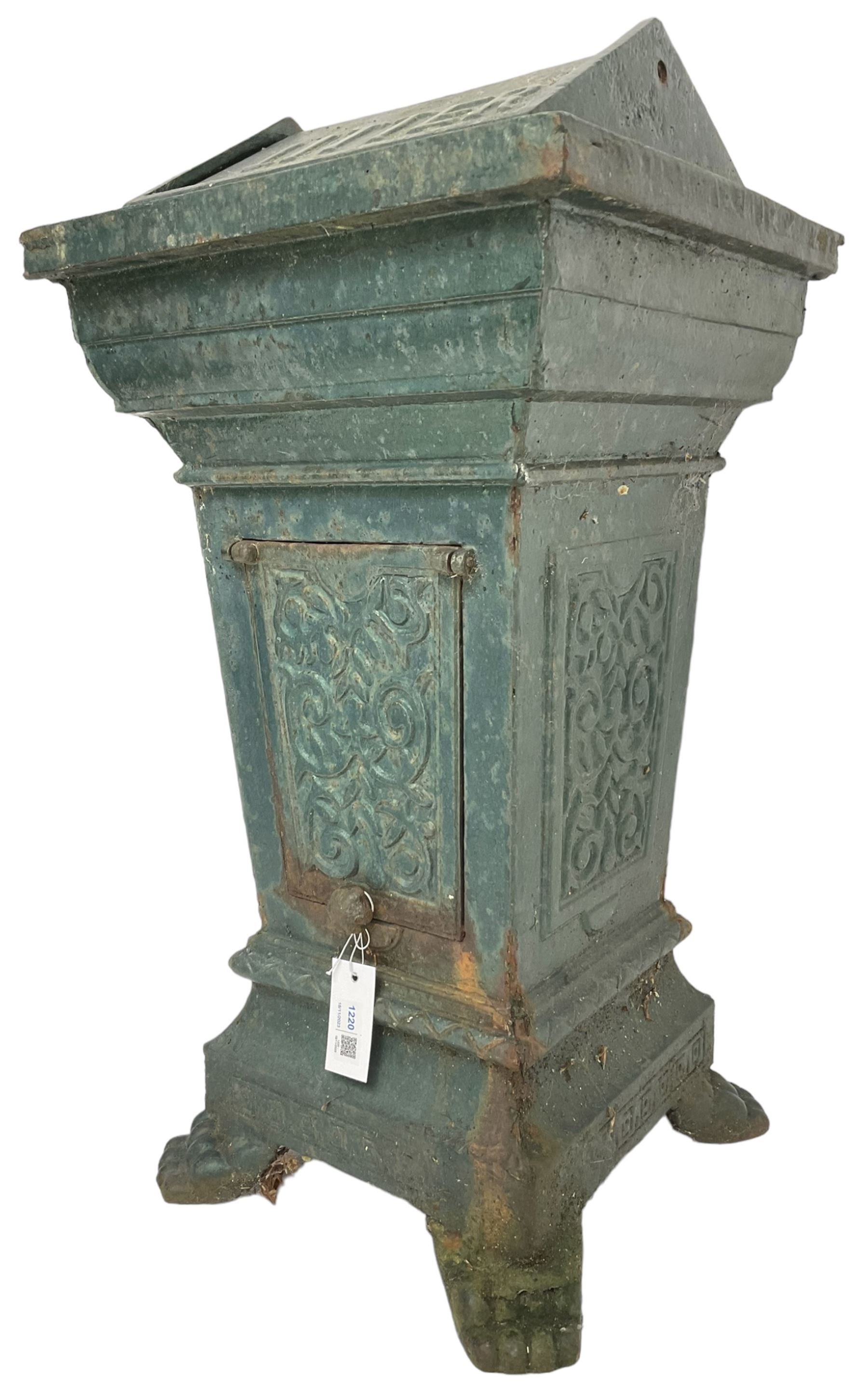 Early 20th century cast iron litter bin, square tapering form with scrolling foliate decoration, on paw feet