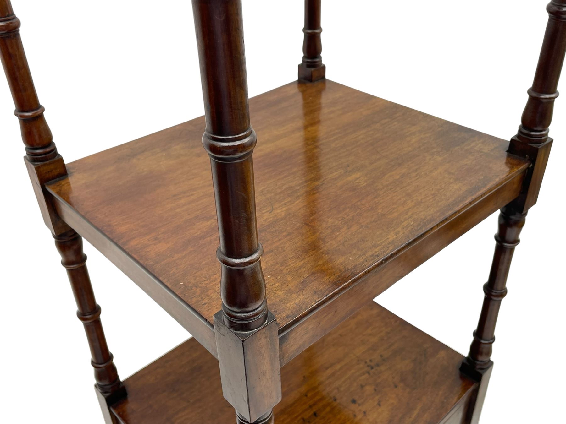 Regency mahogany etagere, the hinged and adjustable top over two tiers and single drawer, turned supports on brass cups and castors 