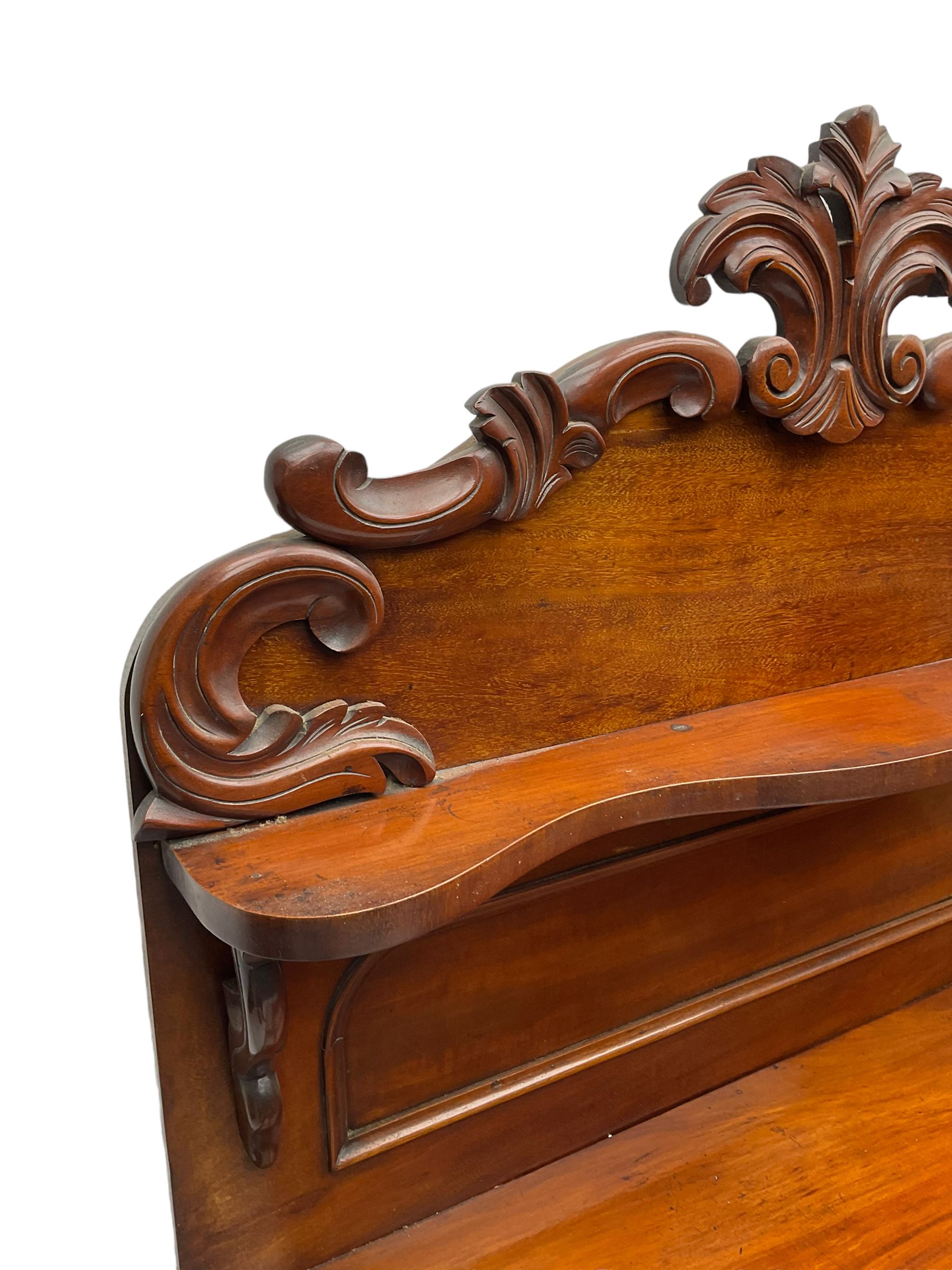 Victorian mahogany chiffonier, raised back with carved C-scroll foliage mounts and shelf, rectangular top with rounded corners over frieze drawer and double panelled cupboard, on skirted base