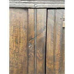 17th century and later oak hall cupboard, panelled front and sides with moulded frame, enclosed by single door with wrought metal hinges and handle, the interior fitted with hooks, on stile supports 