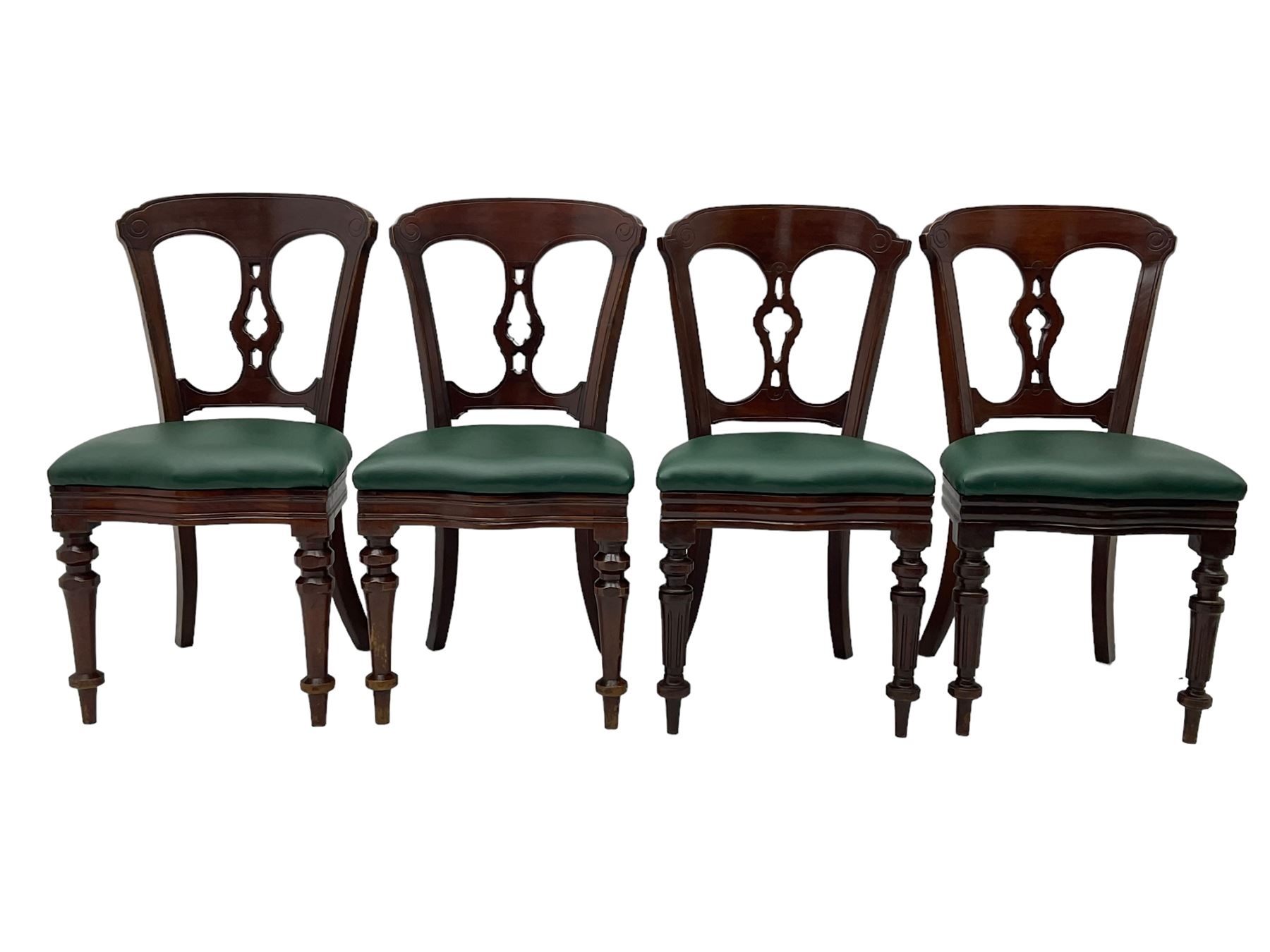 Matched set of twelve Victorian mahogany dining or boardroom chairs, the shaped cresting rail decorated with scrolled decoration, upholstered drop-on seats upholstered in green fabric, on turned supports  