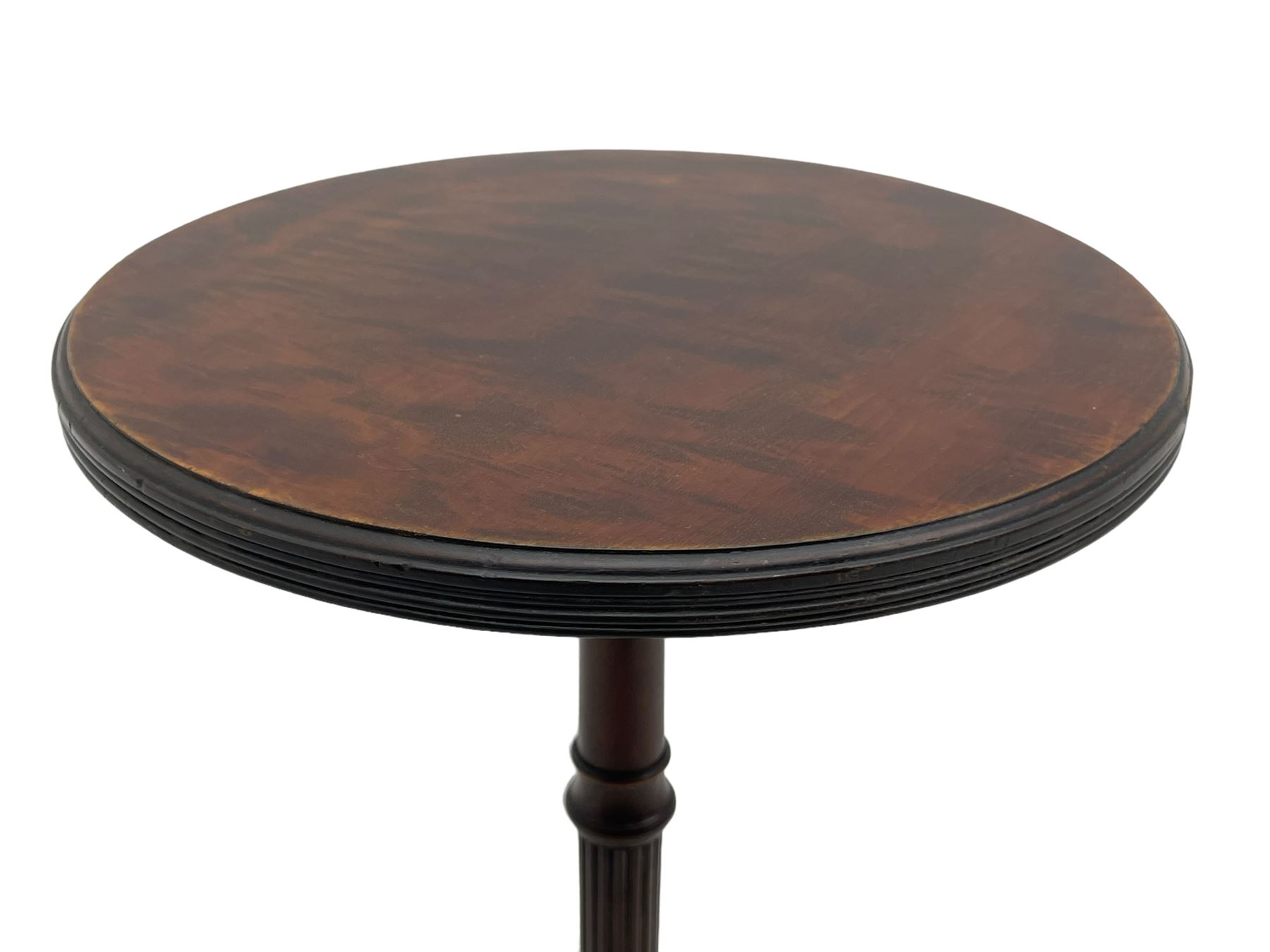 Early 20th century mahogany wine table, figured circular top with reeded edge, on turned and reed moulded stem, three reeded tapered supports on rectangular moulded pad feet 