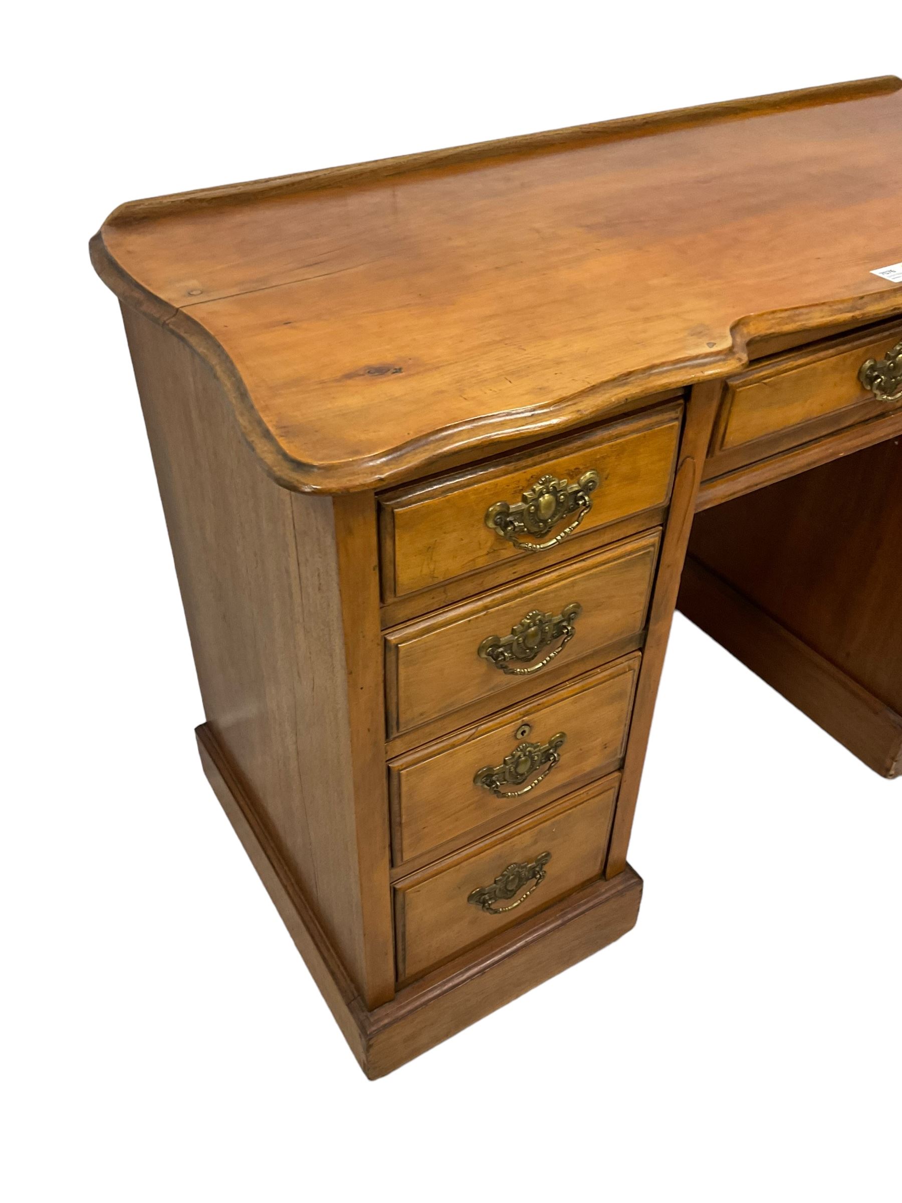 Late 19th century walnut twin pedestal desk, shaped moulded top over nine drawers, on moulded plinth base 