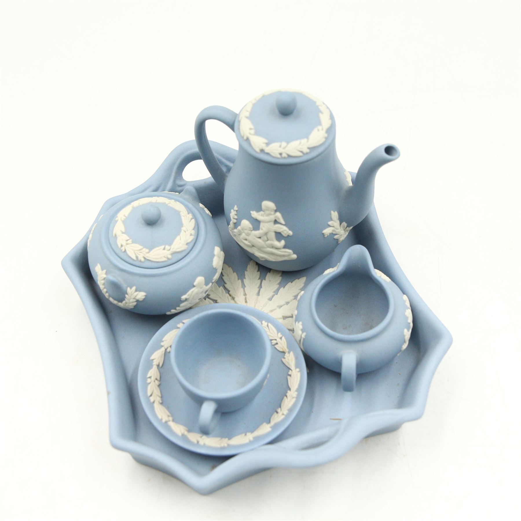 Wedgwood Jasperware miniature tea set for one, on a matched tray, oval scent bottle with silver cover, four caddy spoons, miniature bell, seven thimbles, together with a cased pair of portrait medallions of Josiah Wedgwood FRS and Thomas Bentley 