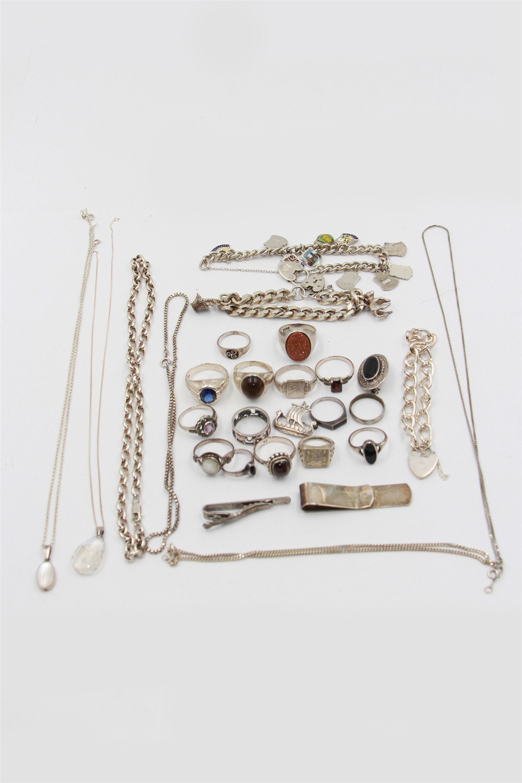 Collection of silver jewellery, including charm bracelet, stone set rings, money clips, chains, rings etc 