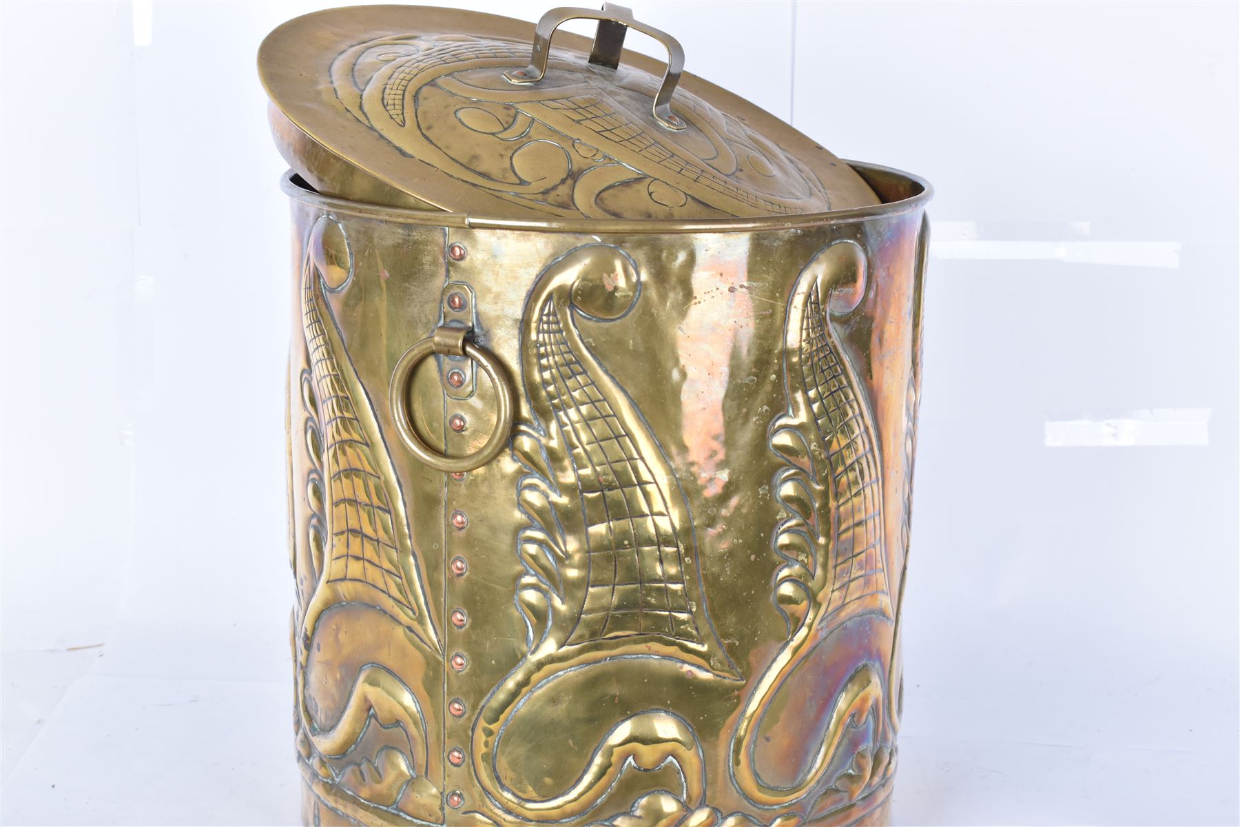 Arts and Craft brass coal box of cylindrical, with embossed stylised leaf panels, with twin handles, the cover with triform handle, H42cm 