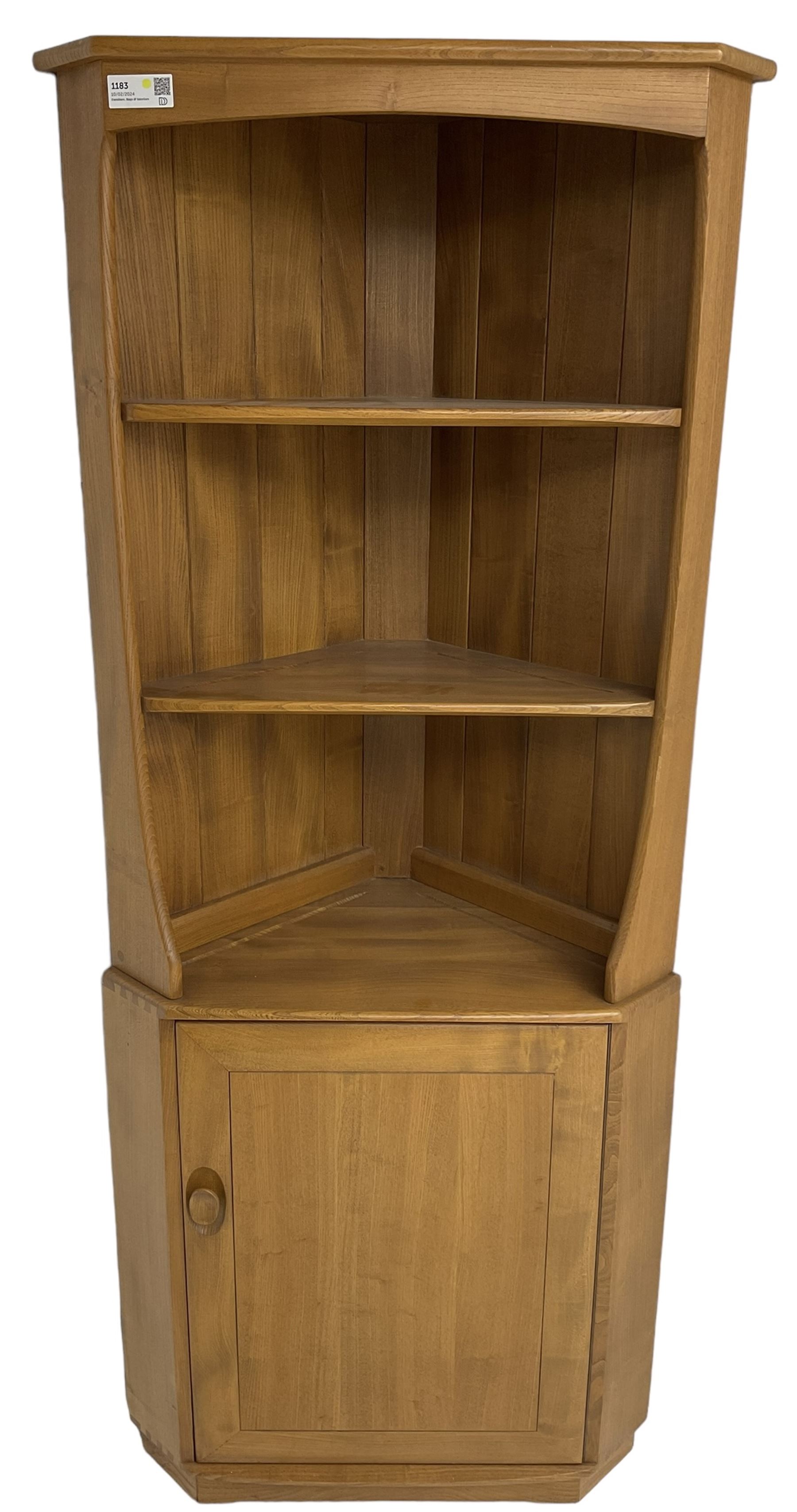 Ercol - mid-20th century '743C'  light elm corner cabinet, fitted with two open shelves over a single cupboard