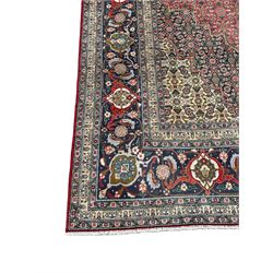 Perisian Bidjar crimson ground rug, within scalloped borders, central pole medallion, the field decorated all over with floral Herati motifs, guarded border decorated with repeating stylised plant motifs and trailing branch 