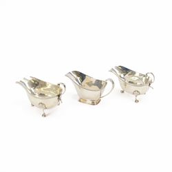 Pair of early 20th century silver sauce boats, of typical form, with flying scroll handle ...