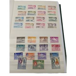 Mostly Commonwealth or Empire stamps including Queen Elizabeth II Northern Rhodesia, Nyasaland, Solomon Islands, Aden, Bermuda, Grenada 'Associated Statehood' overprints, King George VI Falkland Islands Dependencies with values to one shilling etc, mixture of mint and used, housed in a green stockbook