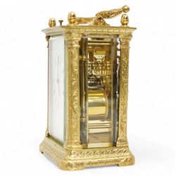 Auguste of Paris - mid-19th century carriage clock in a foliate engraved case with acorn finials and conforming carrying handle, white enamel dial with makers name, Roman numerals, minute track and fine matching steel moon hands,  engraved rear door revealing a twin train going barrel movement striking the hours and half hours on a bell, with the original jewelled lever platform escapement and repeat function, back plate stamped Auguste-Paris, 