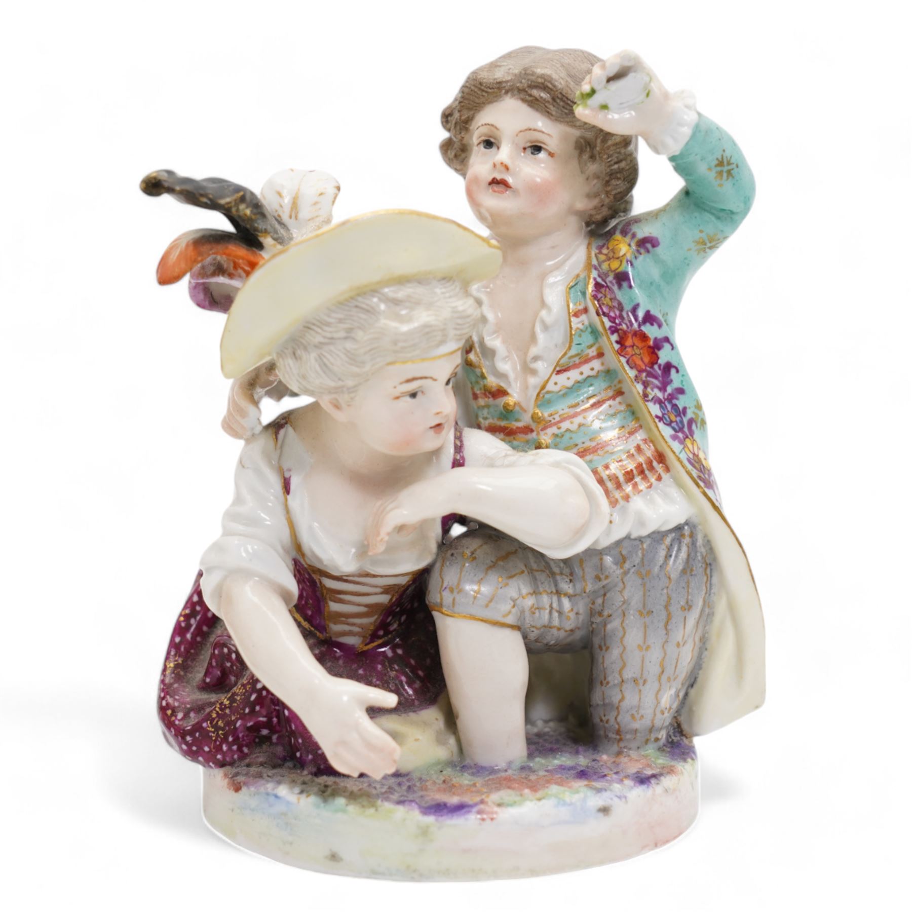 Meissen porcelain group modelled as two cherubs playing with a goat, the oval scroll moulded base heightened in gilt, blue crossed swords, inscribed no. 2454, H10cm, together with a Meissen figure of a young girl and boy, possibly emblematic of autumn, unmarked, (2) Provenance: From the Estate of the late Dowager Lady St Oswald