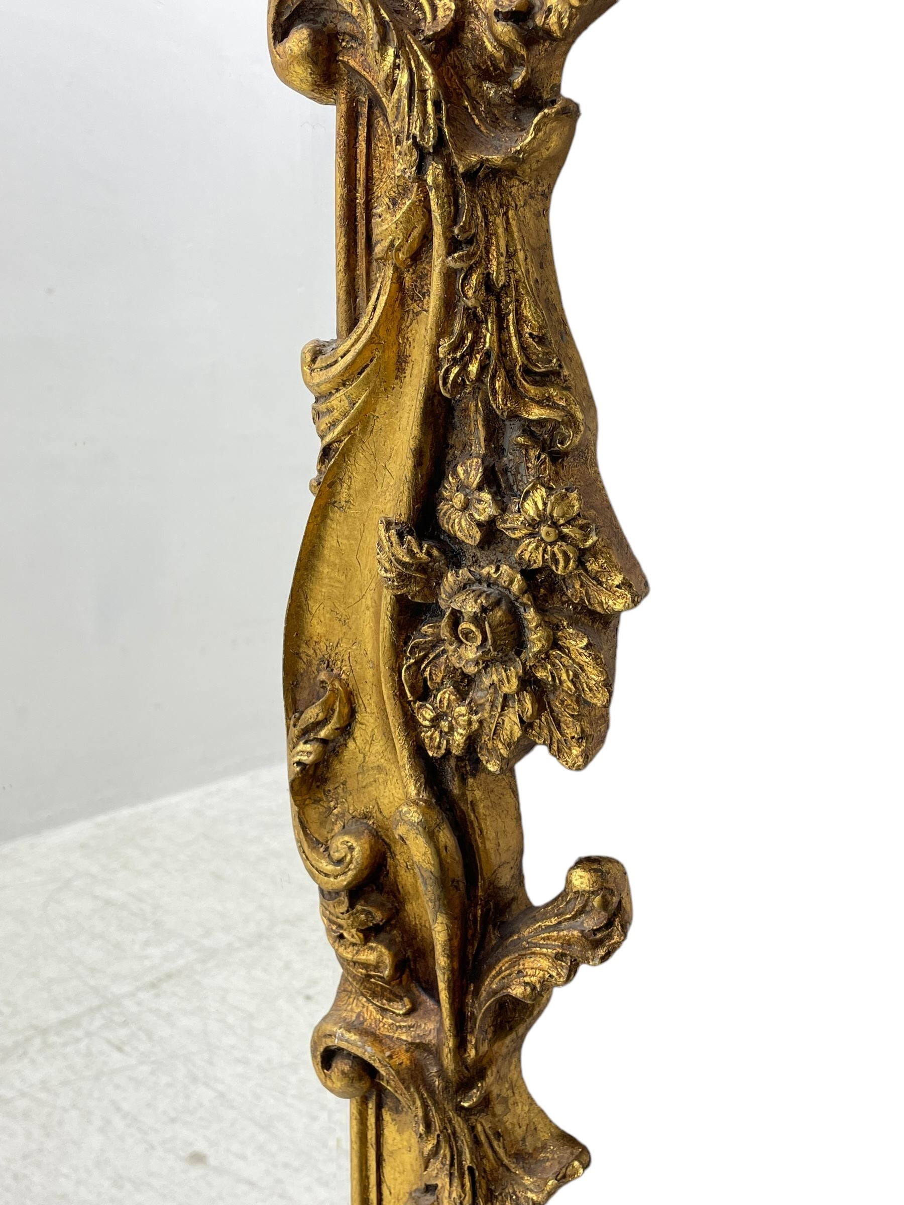 Large gilt framed rectangular wall mirror, shaped and moulded frame decorated with trailing curled acanthus leaves and flower head motifs, bevelled glass plate 