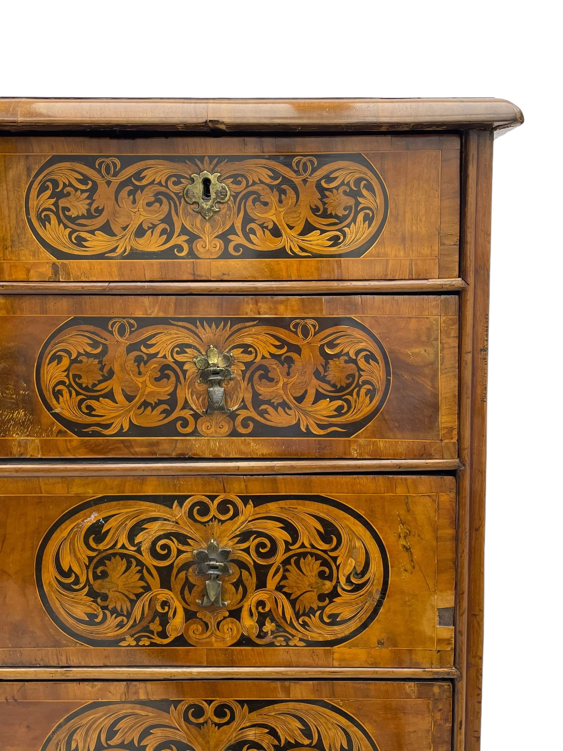 18th century inlaid walnut chest on stand, ovolo-moulded rectangular top inlaid with ebony panels each decorated with scrolling foliage, flower heads and birds, fitted with two short over three long drawers, the drawer fronts decorated with ebony panels enclosing curled leaf inlays, the base fitted with single drawer on turned supports united by waved stretchers, on turned bun feet 