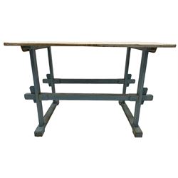 Early 20th century pine rustic dining table, rectangular plank top with weathered patina, over trestle-style supports in distressed blue paint with central stretcher