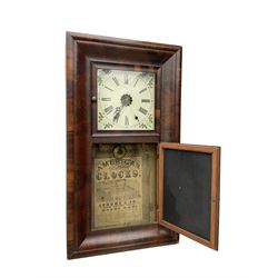 American - 19th century mahogany veneered 8-day ogee shelf clock, rectangular case with two glazed doors to the front, decorative glass tablet to the lower door with a depiction of flowers on a black background with a gold border, painted dial with Roman numerals, minute track, floral spandrels and Maltese cross steel hands, two train weight driven movement, striking the hours on a coiled gong. With the original Jerome trade label pasted on the inner back board of the case.