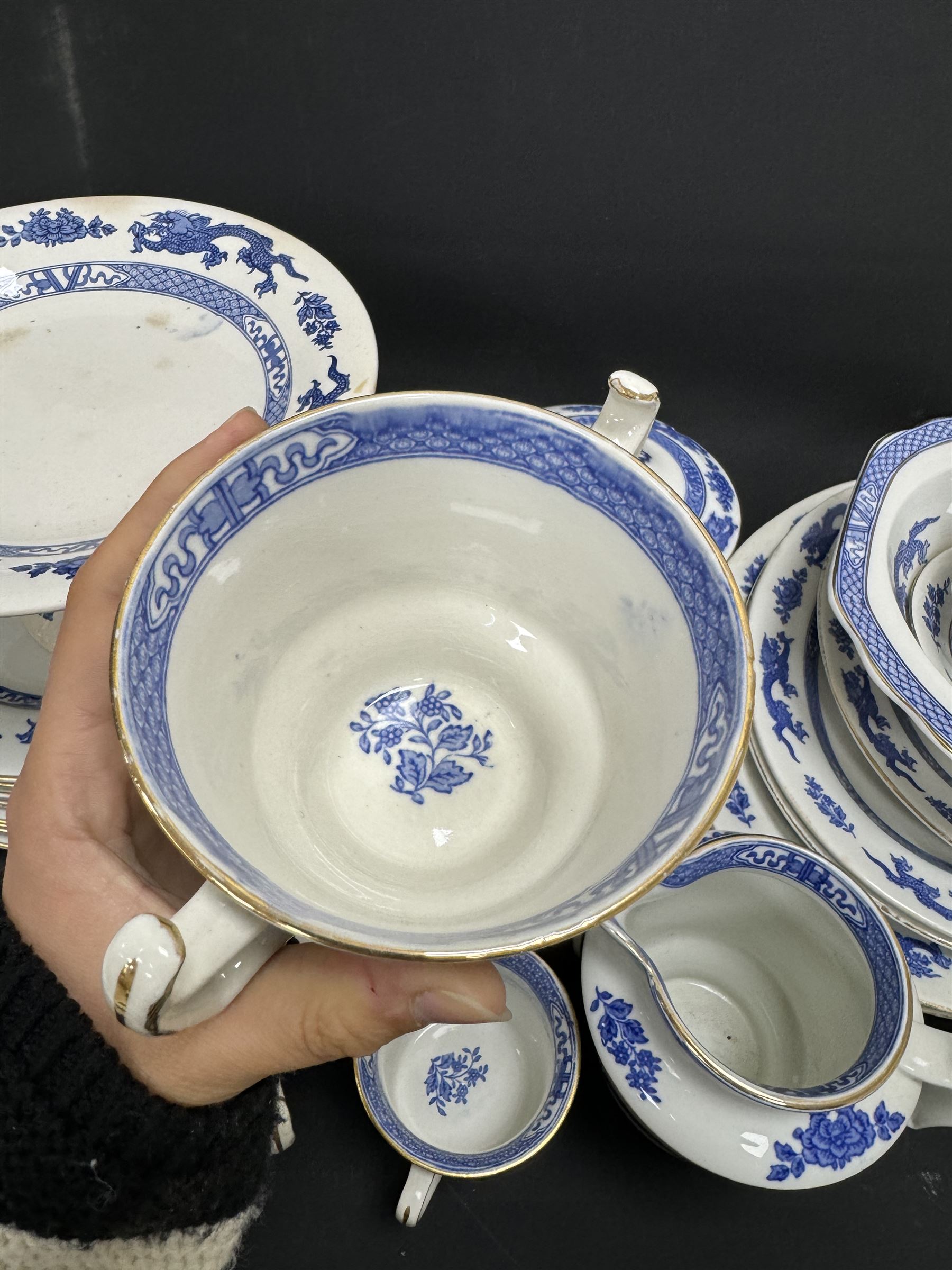 Extensive tea and dinner service of Booths and Cauldon dragon pattern, including, teapots, coffee pots, jugs, toast racks, bowls, dinner plates, platters, soup tureen etc 