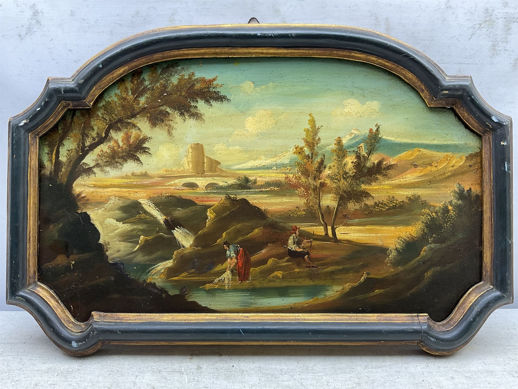 Continental School (19th century): Washerwomen in Capriccio Landscapes, pair oils on shaped panels unsigned 27cm x 46cm (2)