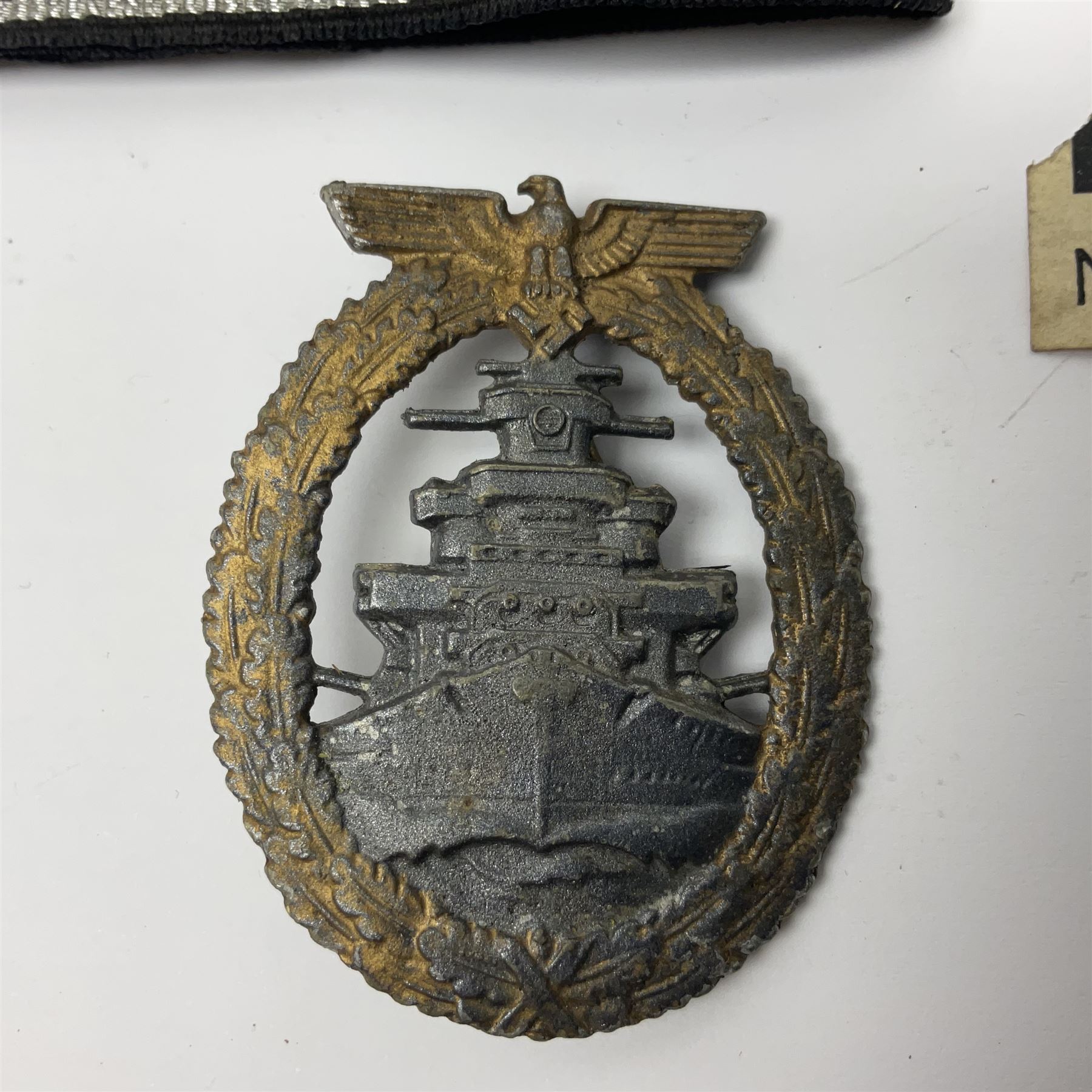 Three Reichsfuhrer 'SS' cuff titles; RZM 'SS' paper tag; German Water Police belt buckle; Destroyers badge marked RKS verso; N.S.B.O. lapel badge; and incomplete party eagle cap badge (8)