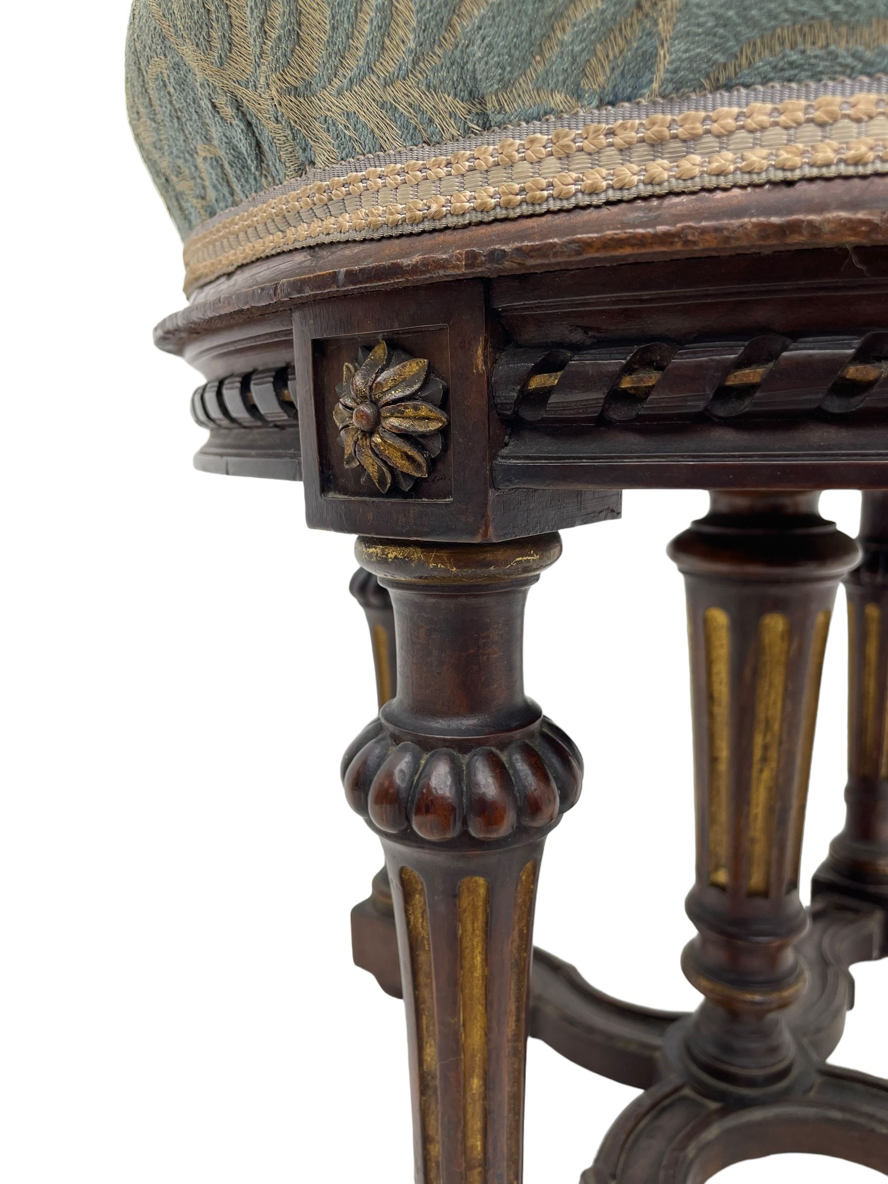 Holland & Sons (London: 1843-1942) - mid-to-late 19th century French design stool, circular form with upholstered cushioned seat in foliate pattern fabric, on lobe carved turned and fluted supports united by shaped X-framed lower stretchers 