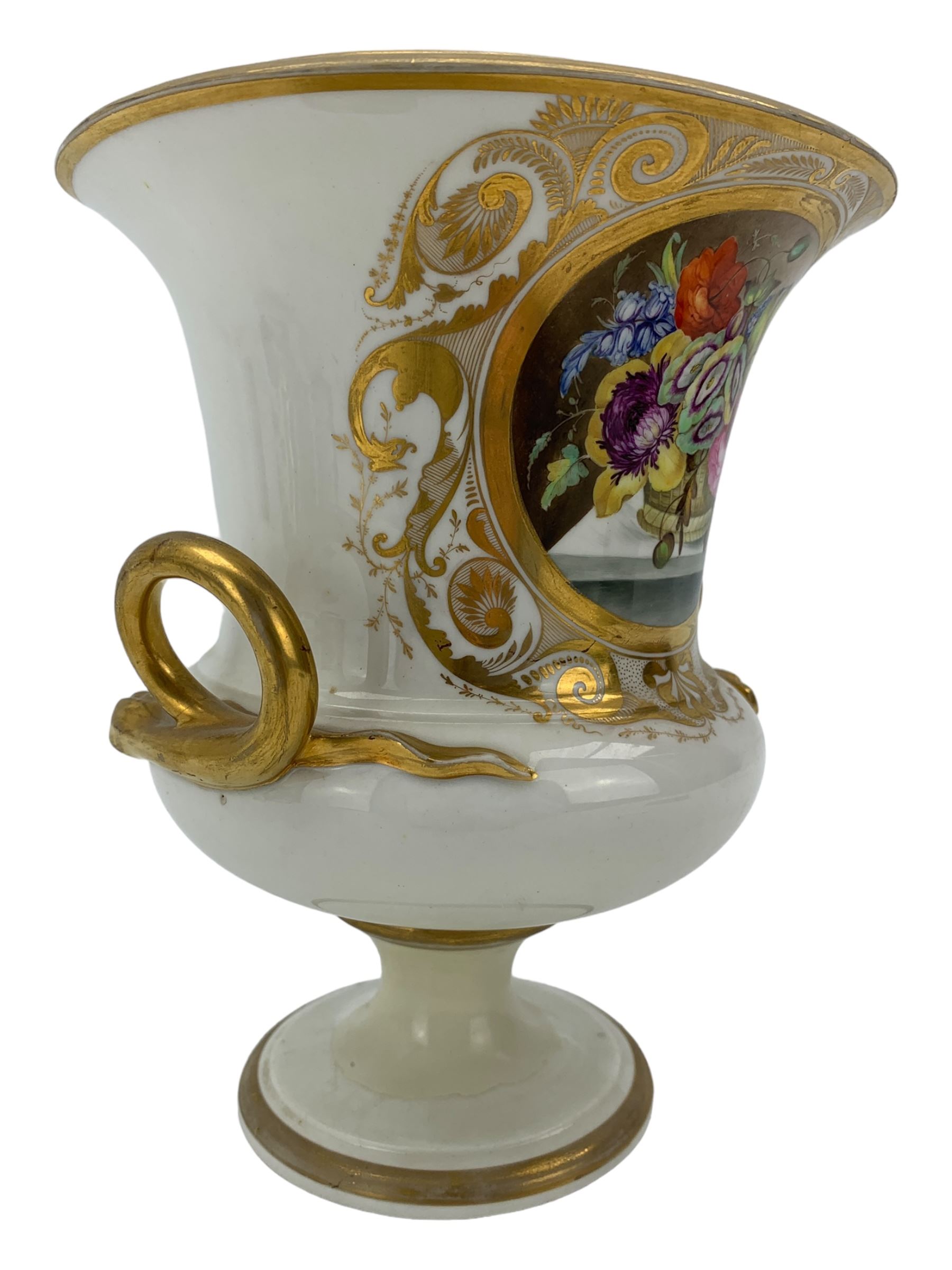 Early 19th century Derby vase, of campana urn form, decorated to one side with a hand painted reserve of a basket of flowers, within a scroll gilt border and twin serpent form handles, H20.5cm together with a Bloor Derby vase, hand painted with figures in a wooded landscape, with twin gilt swan form handles, upon a square pedestal foot, H25cm (2)