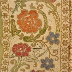 Early 19th century woven silk pelmet, worked in interlaced flowers and tendrils in shades of orange, red, blue and green, within a floral and geometric border, possibly later fringing, L508cm x W33cm