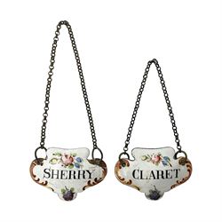 Two late 18th/early 19th century enamel wine labels, each of shaped form, titled 'CLARET', and 'SHERRY' and decorated with floral sprigs and scroll detail upon a white ground, each with suspension chain, each approximately H3.5cm W5cm