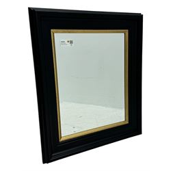 Contemporary gilt framed and ebonised mirror, rectangular broad black outer frame with inner gilt border, bevelled mirror plate 