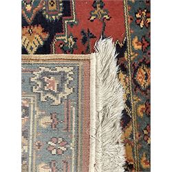 Northwest Persian salmon ground runner, the field decorated with a series of geometric medallions, surrounded by a multi-band border with floral motifs