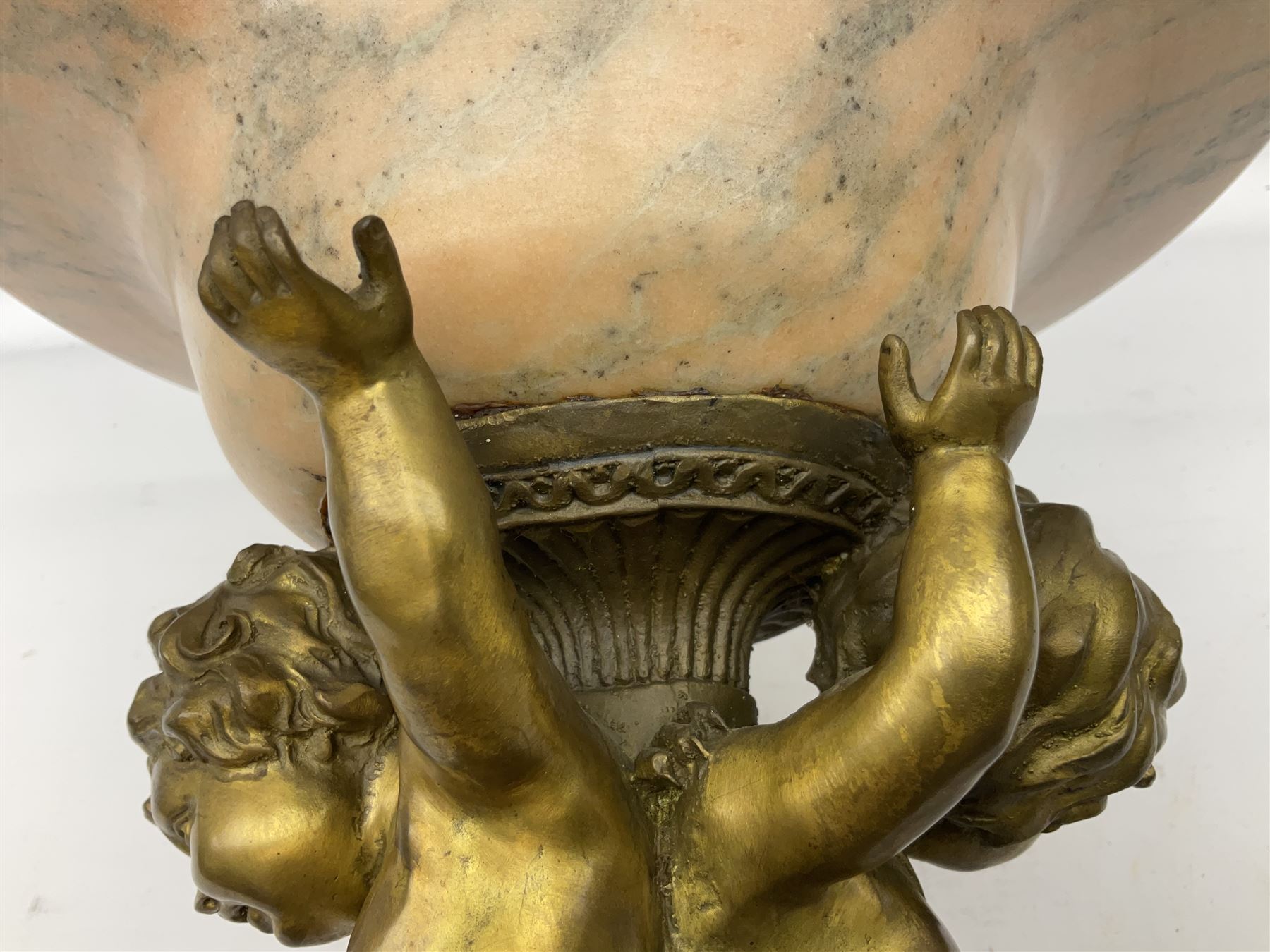 Brass centrepiece modelled as two cherubs supporting a marble bowl, stood upon a foliate design base, H32cm