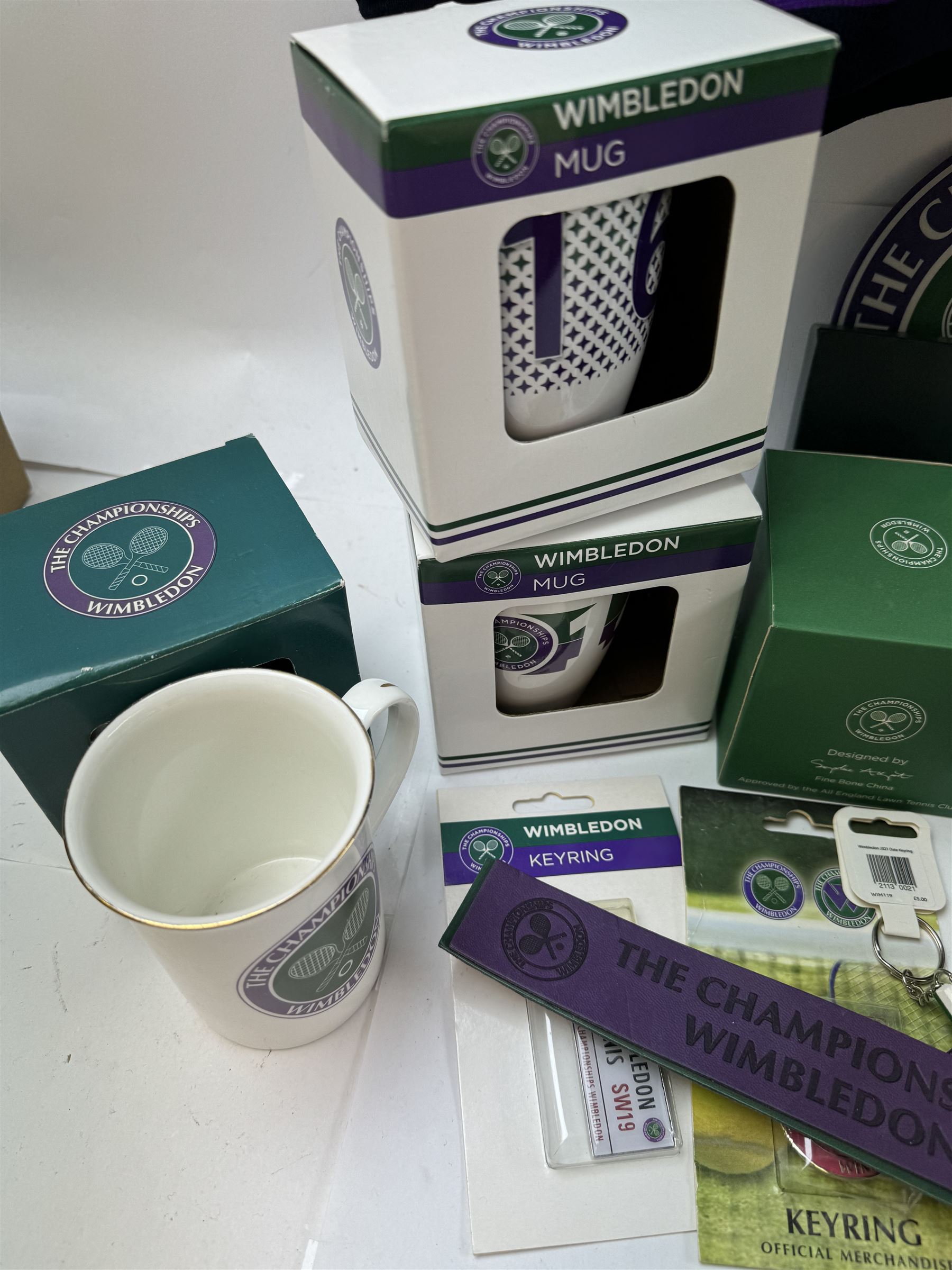 Collection of Wimbledon tennis memorabilia, including towels, programs, mugs, t-shirt, keyrings, ephemera etc