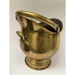 Middle eastern copper bucket, with chased and embossed band of animal decoration, together with a copper jardinière embossed with floral panels, copper plate with embossed leaf motif and two brass helmet shaped coal scuttles, bucket H26cm